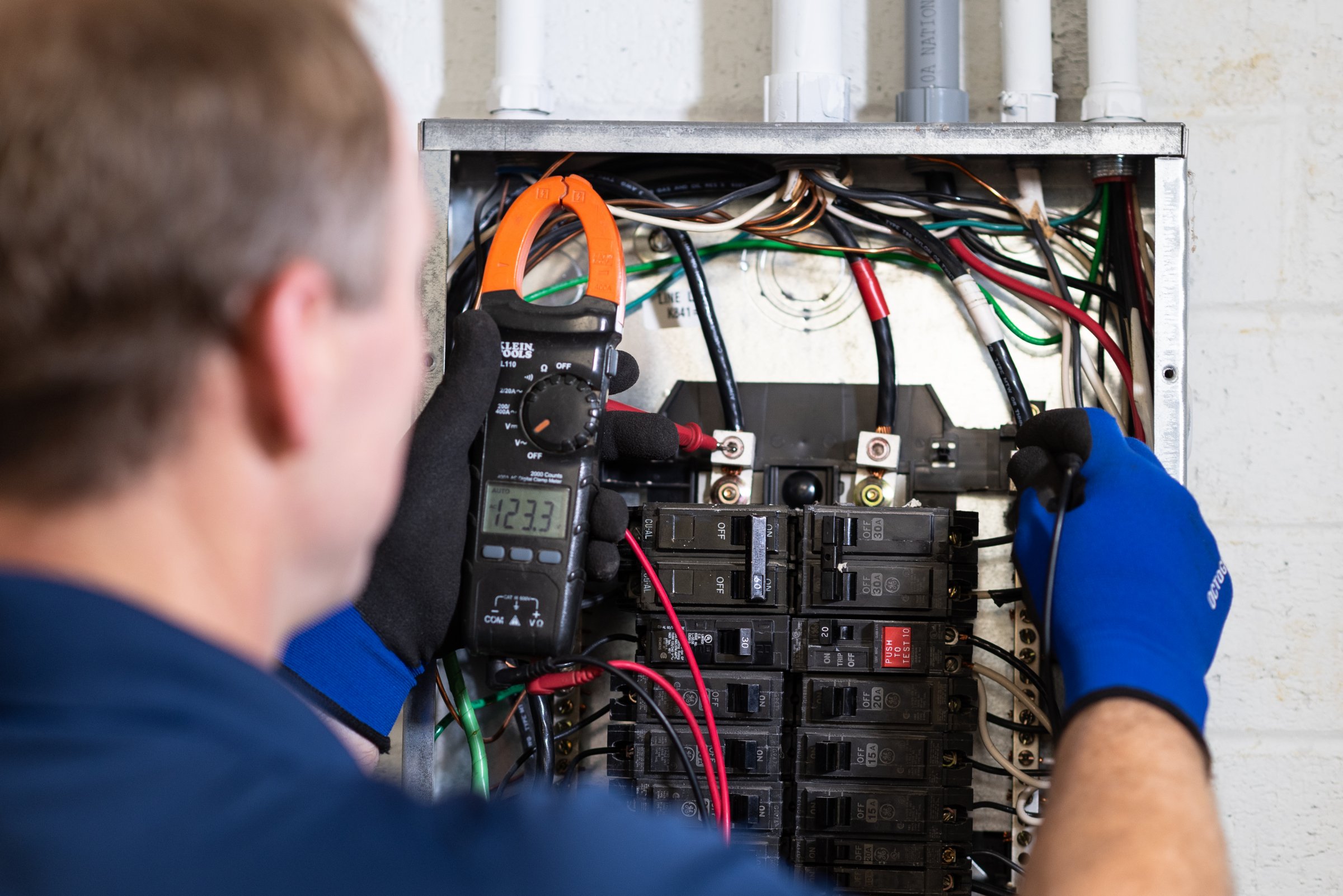 Electrician working on breaker panel